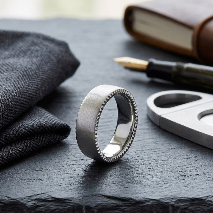 7.5mm Satin Finish Carved Wedding Band in 18K White Gold, on walnut surface with pocket square