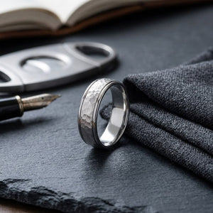 6mm Hammered Finish Carved Wedding Band in 18K White Gold, on walnut surface with pocket square