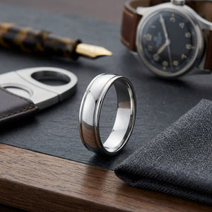 6mm High Polish Round Edge Carved Wedding Band in 18K White Gold, on walnut surface with pocket square