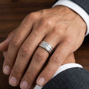 7.5mm High Polish Round Edge Carved Wedding Band in 18K White Gold, worn on hand, masculine close-up