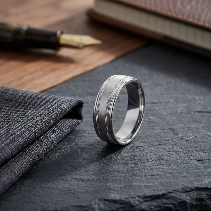 7mm Round Edge Swirl Finish Carved Wedding Band in 18K White Gold, on walnut surface with pocket square