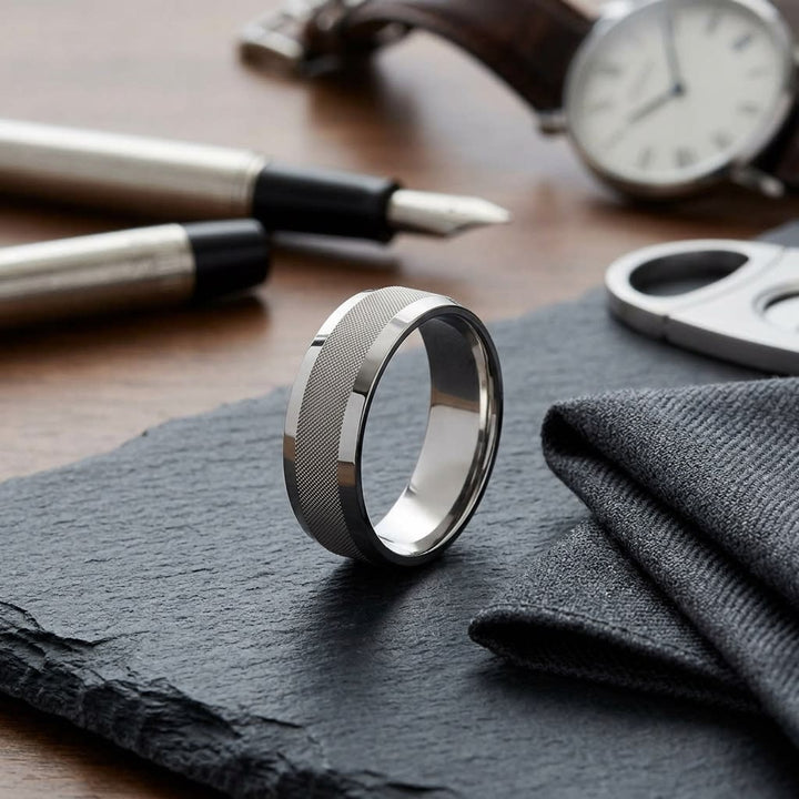 7mm High Polish Cross Hatch Center Carved Wedding Band in 18K White Gold, on walnut surface with pocket square