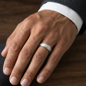 6.5mm Round Edge Swirl Finish Carved Wedding Band in 18K White Gold, worn on hand, masculine close-up