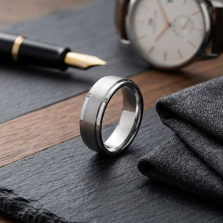 7mm Satin Finish Carved Wedding Band in 18K White Gold, on walnut surface with pocket square