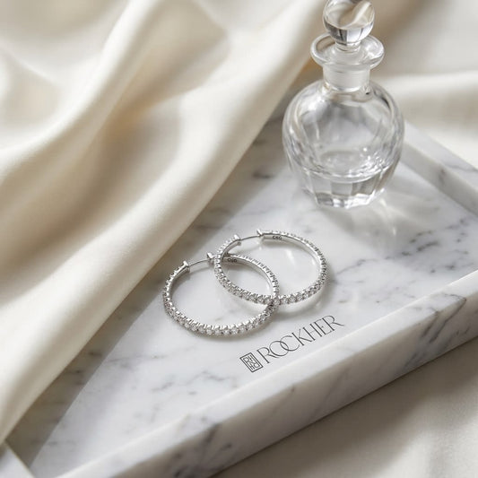 Diamond Hoop Earrings in 18K Yellow Gold, on marble vanity tray with silk