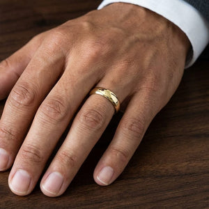 5.5mm Deluxe Comfort-Fit Wedding Band in 18K Yellow Gold, worn on hand, masculine close-up