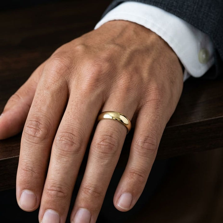 6mm High Dome Comfort-Fit Wedding Band in 18K Yellow Gold, worn on hand, masculine close-up