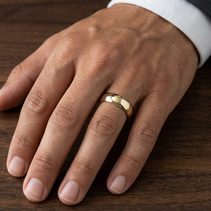 7mm High Dome Comfort-Fit Wedding Band in 18K Yellow Gold, worn on hand, masculine close-up