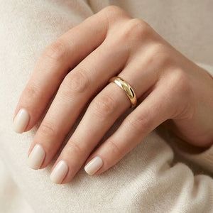 4mm Slightly Domed Comfort-Fit Wedding Band in 18K Yellow Gold, worn on hand, close-up