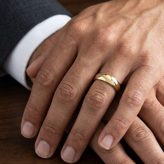 7mm Slightly Domed Comfort-Fit Wedding Band in 18K Yellow Gold, worn on hand, masculine close-up