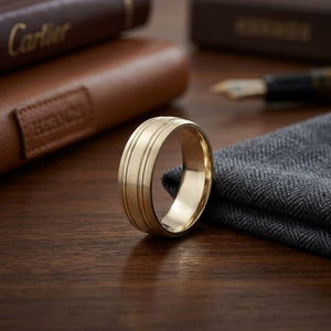 7mm Satin Finish Parallel Groove Carved Wedding Band in 18K Yellow Gold, on walnut surface with pocket square