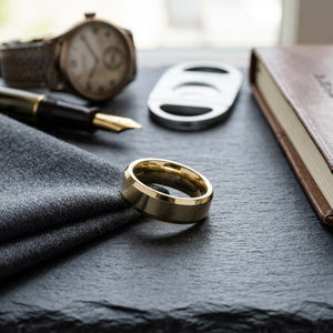 6mm High Polish Carved Wedding Band in 18K Yellow Gold, on walnut surface with pocket square
