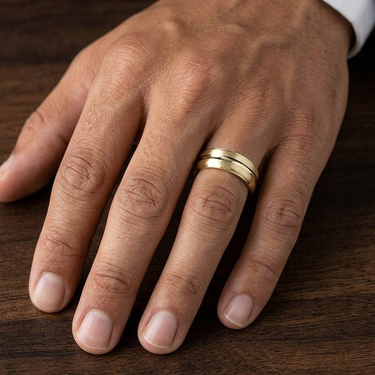 7.5mm Satin Finish High Polished Center Cut Carved Wedding Band in 18K Yellow Gold, worn on hand, masculine close-up