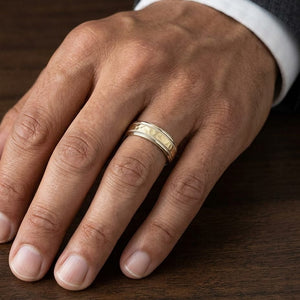 6mm Hammered Center High Polish Round Edge Carved Wedding Band in 18K Yellow Gold, worn on hand, masculine close-up