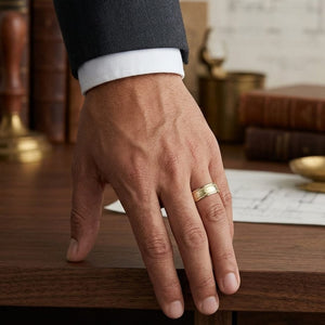 8mm Hammered Center High Polish Round Edge Carved Wedding Band in 18K Yellow Gold, worn on hand, masculine full view