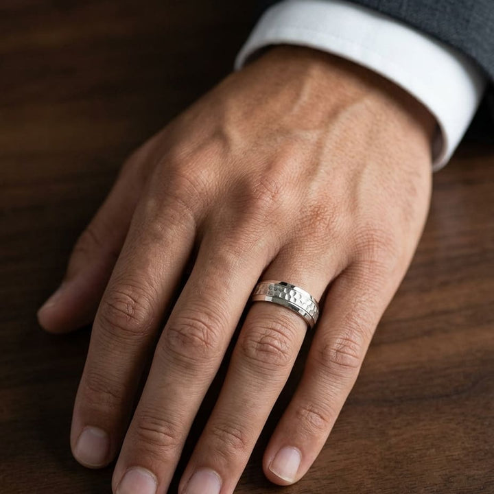 7.5mm Hammered Finish Beveled Edge Carved Wedding Band in 18K Yellow Gold, worn on hand, masculine close-up