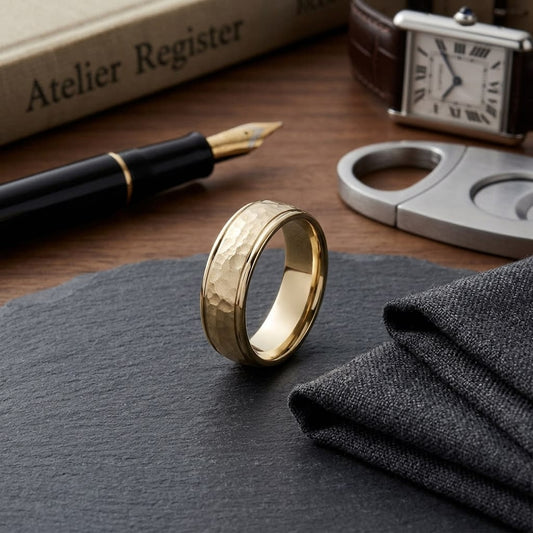 6mm Hammered Finish Carved Wedding Band in 18K Yellow Gold, on walnut surface with pocket square
