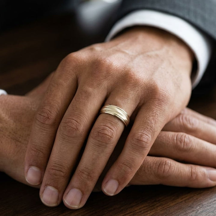 6mm High Polish Round Edge Carved Wedding Band in 18K Yellow Gold, worn on hand, masculine close-up