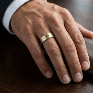6mm Satin Finish High Polished Center Cut Carved Wedding Band in 18K Yellow Gold, worn on hand, masculine close-up