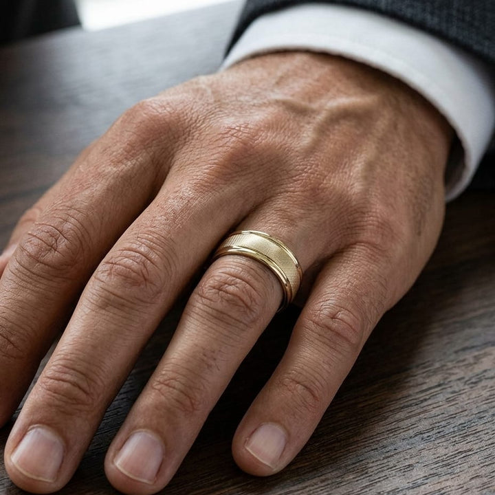 7mm Florentine Center High Polish Round Edge Carved Wedding Band in 18K Yellow Gold, worn on hand, masculine close-up