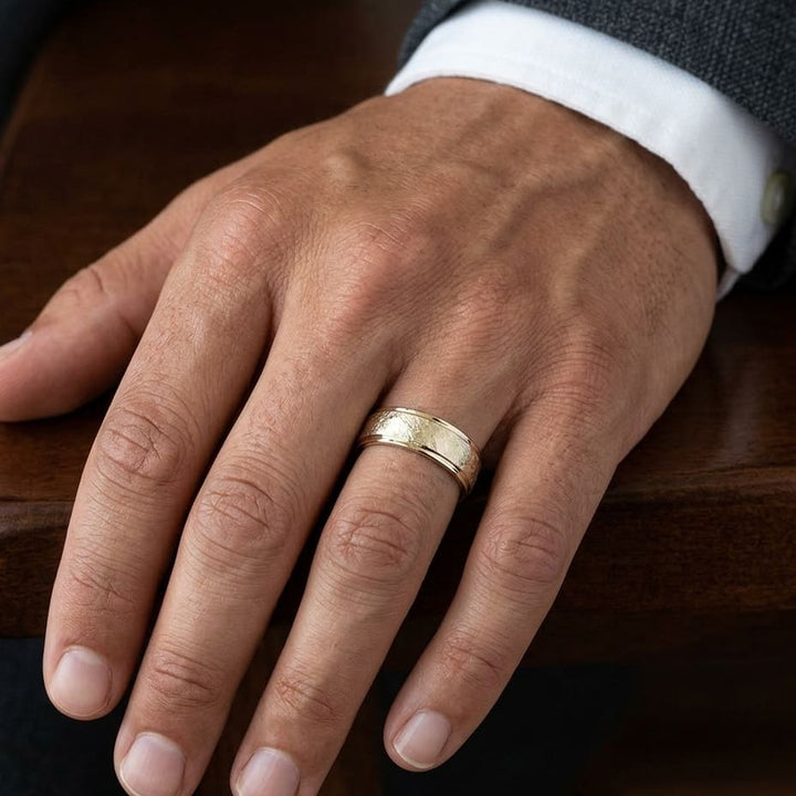 6.5mm Round Edge Swirl Finish Carved Wedding Band in 18K Yellow Gold, worn on hand, masculine close-up