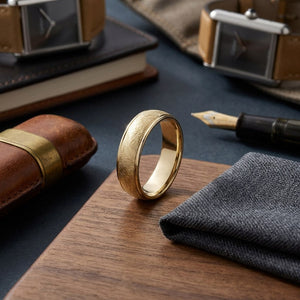7mm Comfort-Fit Wedding Band in 18K Yellow Gold, on walnut surface with pocket square