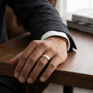 7mm Satin Finish Carved Wedding Band in 18K Yellow Gold, worn on hand, masculine full view
