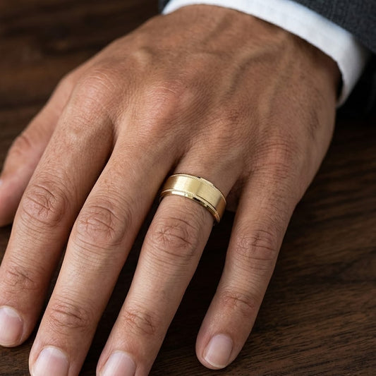 8mm Satin Finish Carved Wedding Band in 18K Yellow Gold, worn on hand, masculine close-up