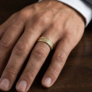 6mm Celtic Knot Carved Wedding Band in 18K Yellow Gold, worn on hand, masculine close-up
