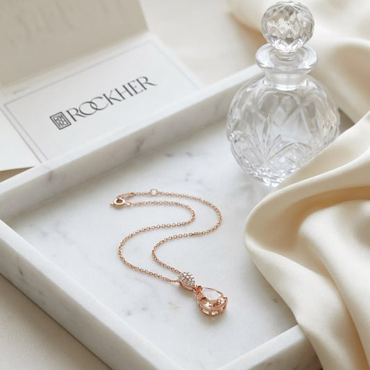 Morganite Pear Shape Pendant in 14K Rose Gold, on marble vanity tray with silk