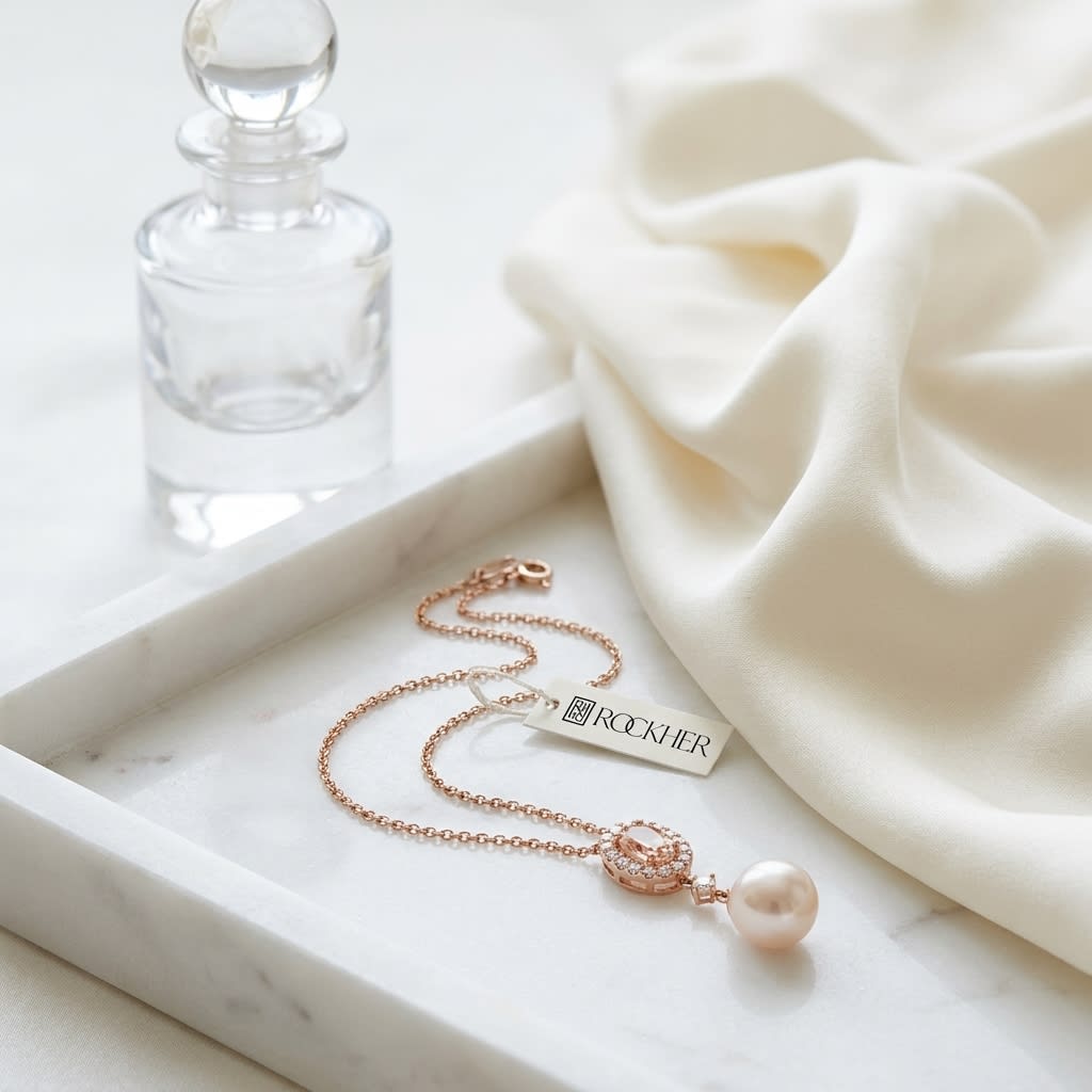 Morganite Pear Shape Pendant in 14K Rose Gold, on marble vanity tray with silk