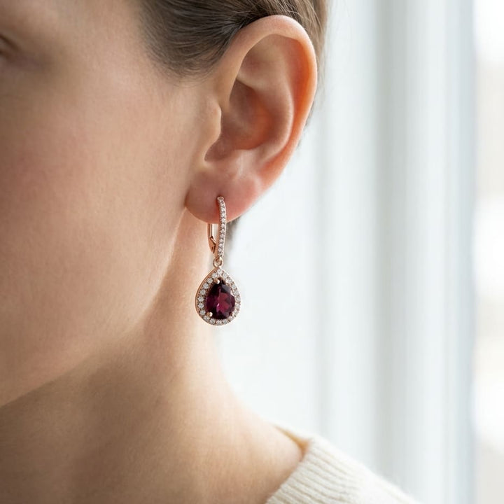 Rhodolite Garnet And Diamond Teardrop Halo Dangling Earrings in 14K Rose Gold, worn close-up portrait