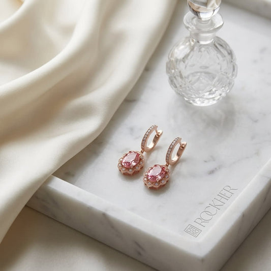 Oval Pink Tourmaline A Diamond Halo Earrings in 14K Rose Gold, on marble vanity tray with silk
