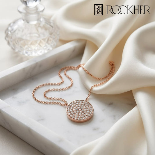 Diamond Pave Round Disk Necklace in 14K Rose Gold, on marble vanity tray with silk