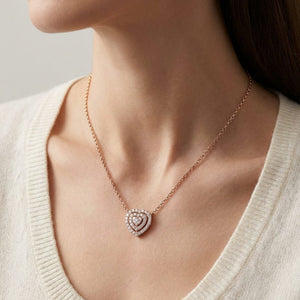 Diamond Heart Cluster Necklace With Pave Double Border in 14K Rose Gold, worn close-up portrait