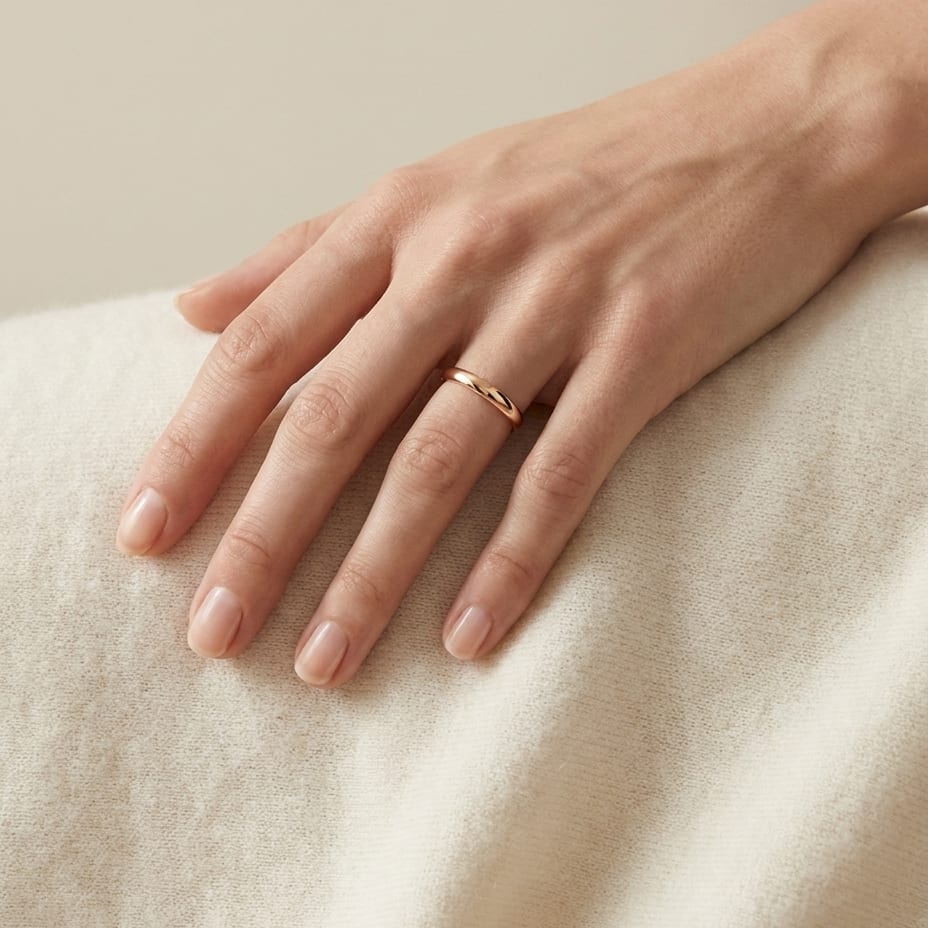 2mm Slightly Domed Traditional Oval Wedding Band in 14K Rose Gold, worn on hand, full view