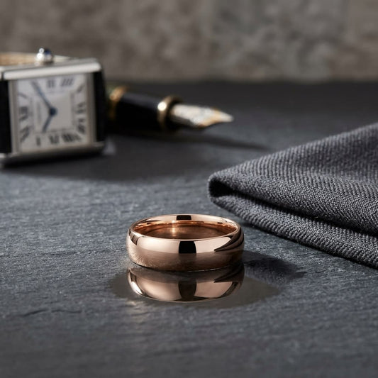 6mm Slightly Domed Traditional Oval Wedding Band in 14K Rose Gold, on walnut surface with pocket square