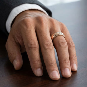 5mm Slightly Domed Traditional Oval Milgrain Wedding Band in 14K Rose Gold, worn on hand, masculine close-up