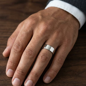 8mm Flat Comfort-Fit Wedding Band in 14K Rose Gold, worn on hand, masculine close-up