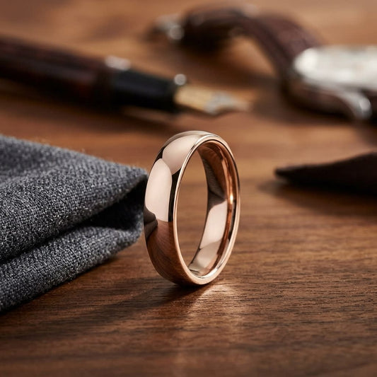 5.5mm Deluxe Comfort-Fit Wedding Band in 14K Rose Gold, on walnut surface with pocket square