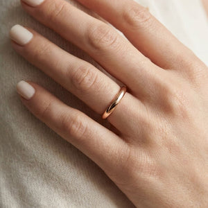 2mm Slightly Domed Comfort-Fit Wedding Band in 14K Rose Gold, worn on hand, close-up