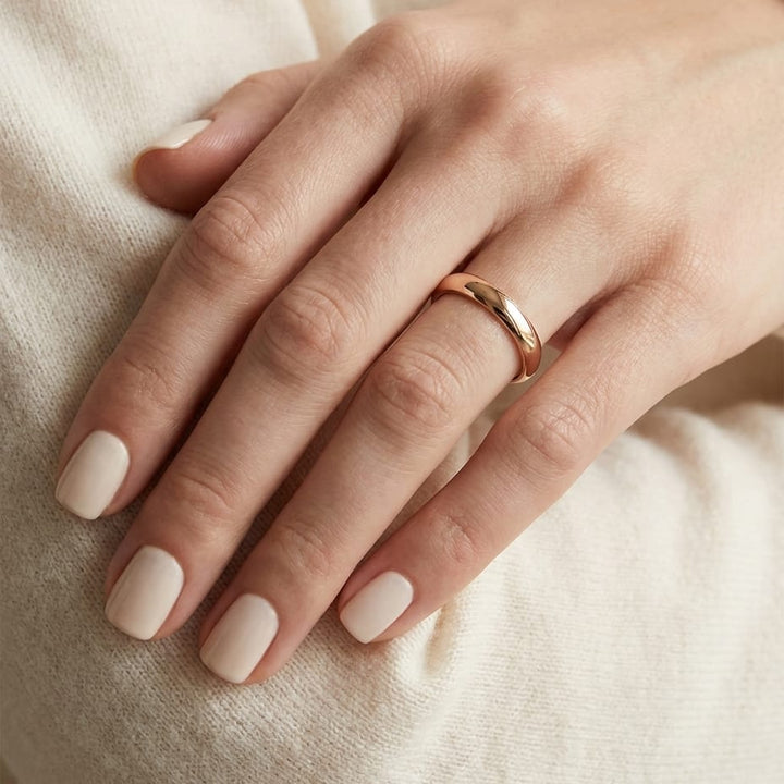 3mm Slightly Domed Comfort-Fit Wedding Band in 14K Rose Gold, worn on hand, close-up