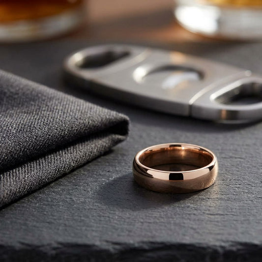 6mm Slightly Domed Comfort-Fit Wedding Band in 14K Rose Gold, on walnut surface with pocket square