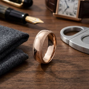 7mm Slightly Domed Double Milgrain Comfort-Fit Wedding Band in 14K Rose Gold, on walnut surface with pocket square