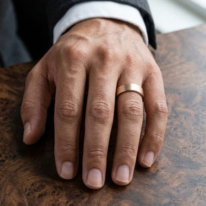 6mm Satin Finish Carved Wedding Band in 14K Rose Gold, worn on hand, masculine close-up