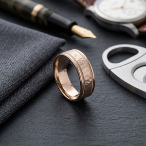 8mm Hammered Center High Polish Round Edge Carved Wedding Band in 14K Rose Gold, on walnut surface with pocket square