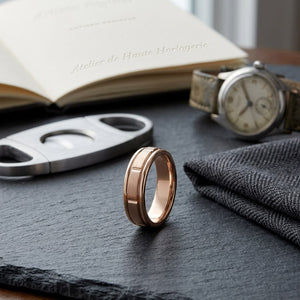 6mm Satin Finish High Polished Center Cut Carved Wedding Band in 14K Rose Gold, on walnut surface with pocket square