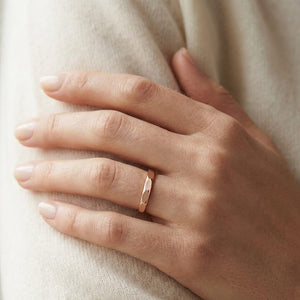 2mm High Polish Carved Wedding Band in 14K Rose Gold, worn on hand, close-up
