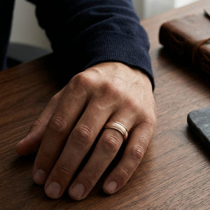 7mm Florentine Center High Polish Round Edge Carved Wedding Band in 14K Rose Gold, worn on hand, masculine full view