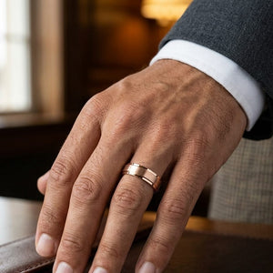 7mm Satin Finish Carved Wedding Band in 14K Rose Gold, worn on hand, masculine close-up